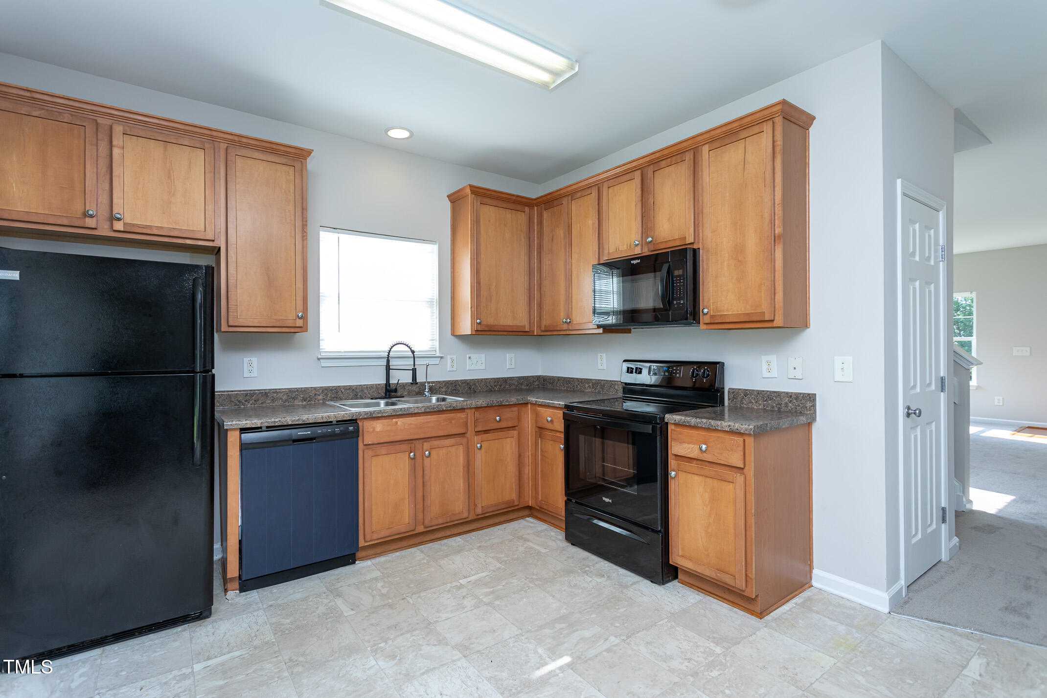 601 Weeping Willow Drive Durham, NC 27704 - Photo 23 of 36 a kitchen with granite countertop stainless steel appliances a stove sink and microwave