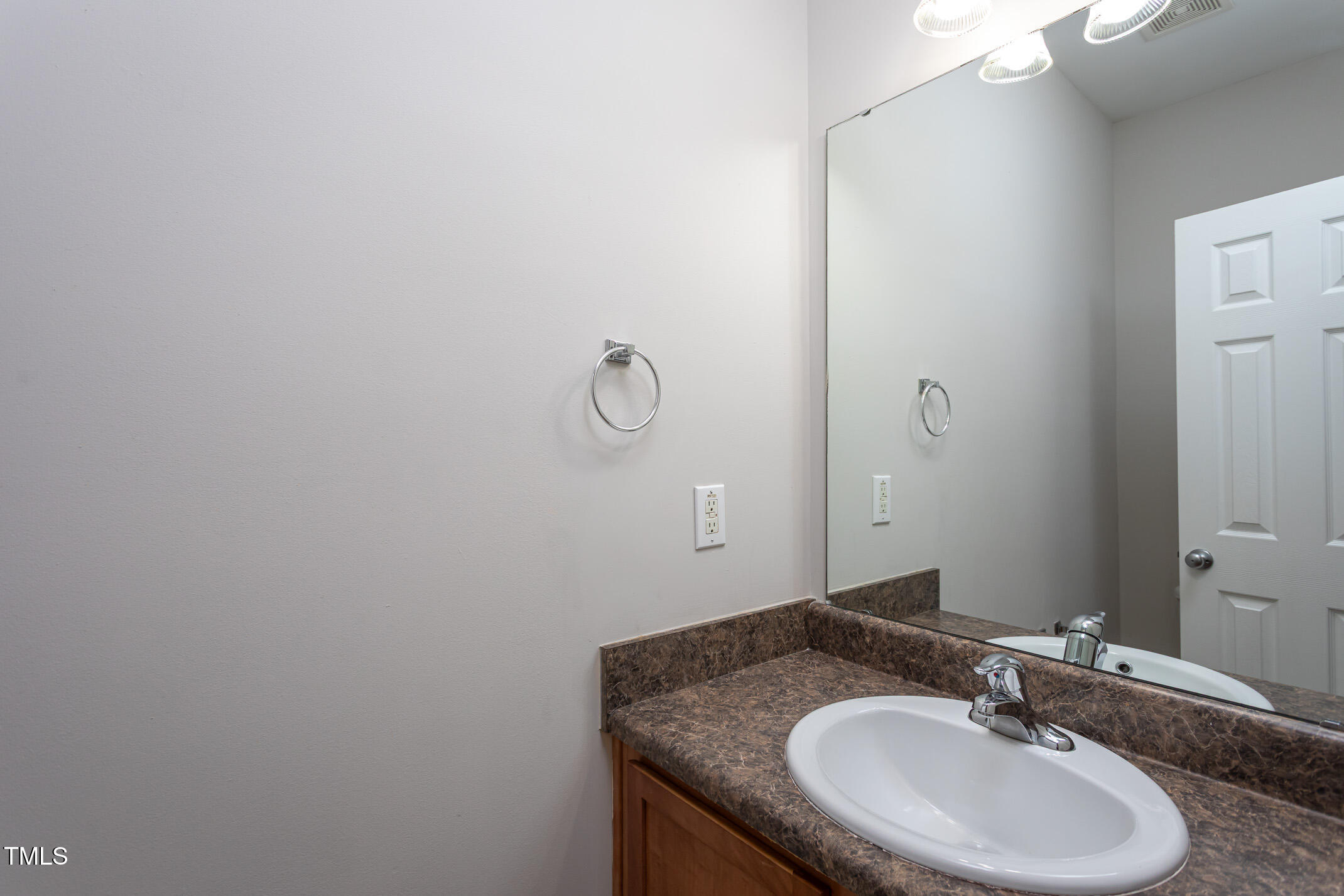 601 Weeping Willow Drive Durham, NC 27704 - Photo 27 of 36 a bathroom with a granite countertop sink and a mirror