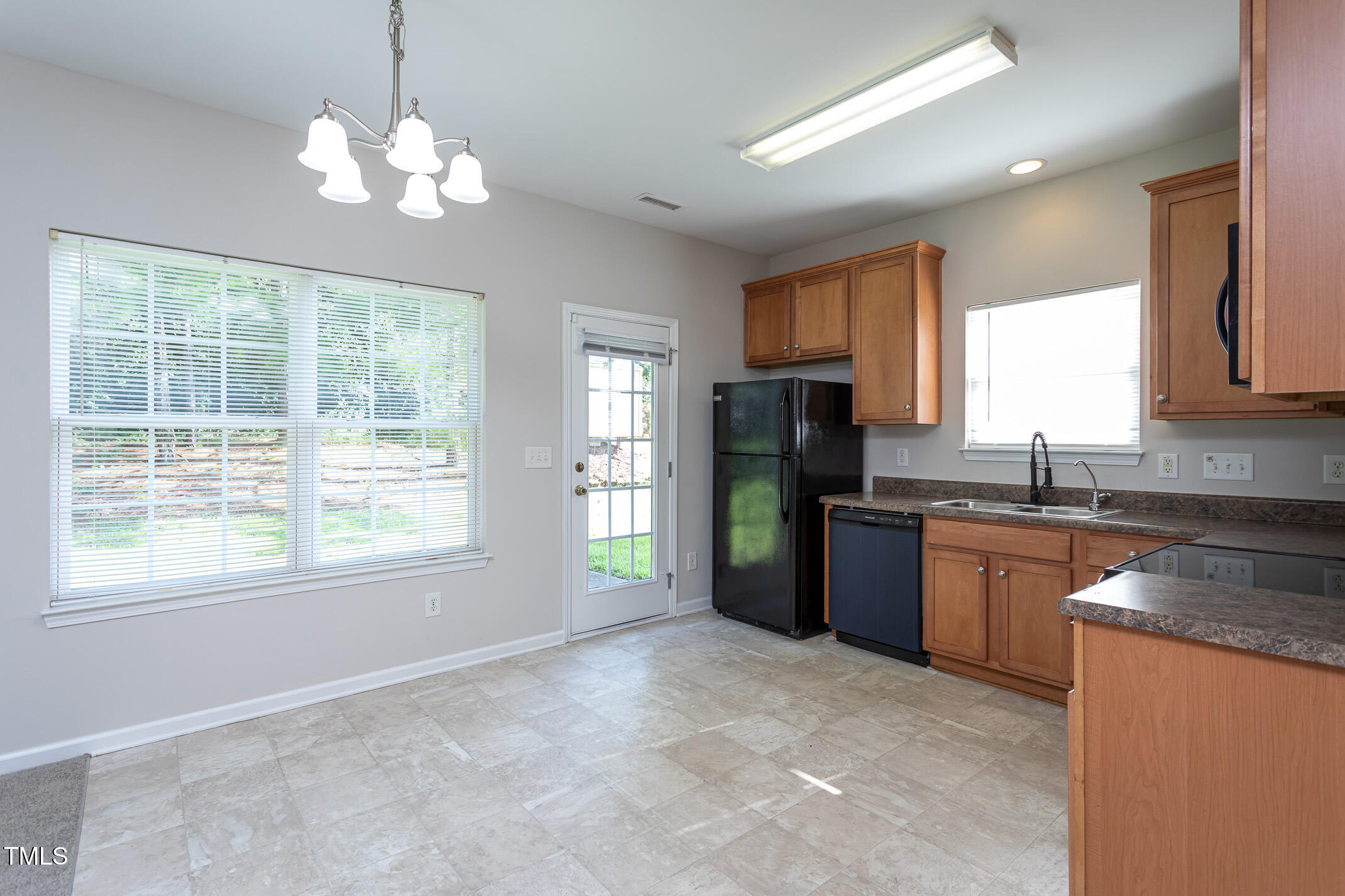 601 Weeping Willow Drive Durham, NC 27704 - Photo 3 of 36 a kitchen with granite countertop a refrigerator and a sink