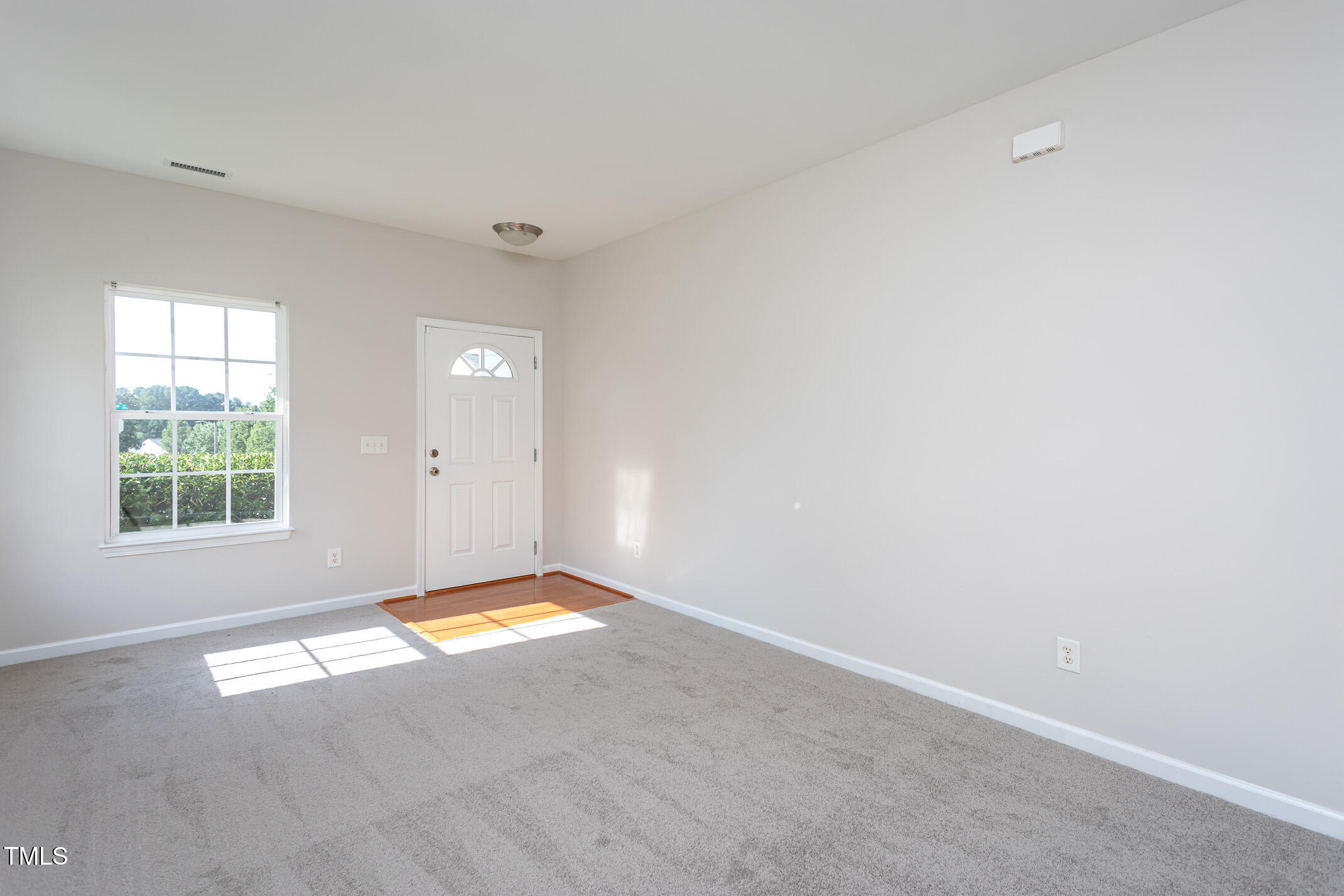601 Weeping Willow Drive Durham, NC 27704 - Photo 8 of 36 a view of an empty room with a window