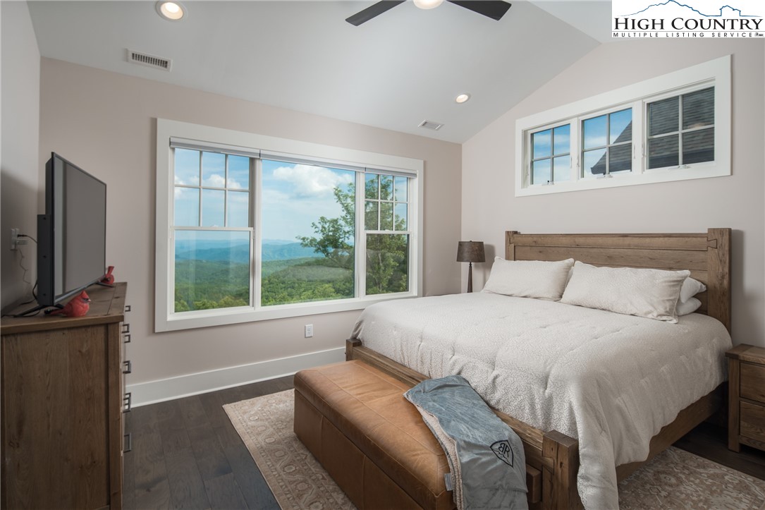 103 Dugger Rdg Trail Boone, NC 28607 - Photo 16 of 49 a bedroom with a large bed and a flat tv screen on dresser