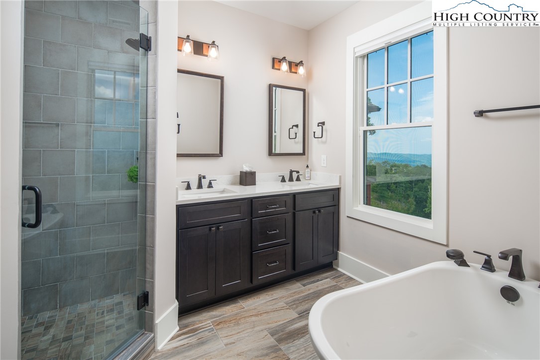 103 Dugger Rdg Trail Boone, NC 28607 - Photo 18 of 49 a bathroom with a double vanity sink mirror and bathtub