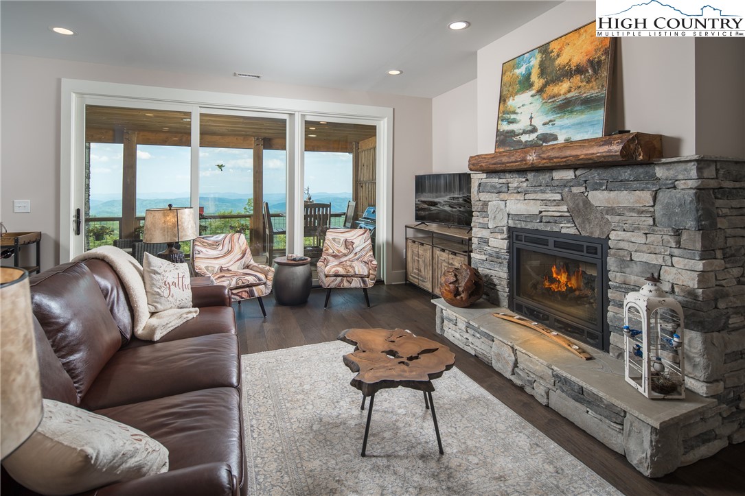 103 Dugger Rdg Trail Boone, NC 28607 - Photo 2 of 49 a living room with furniture a large window and a fireplace