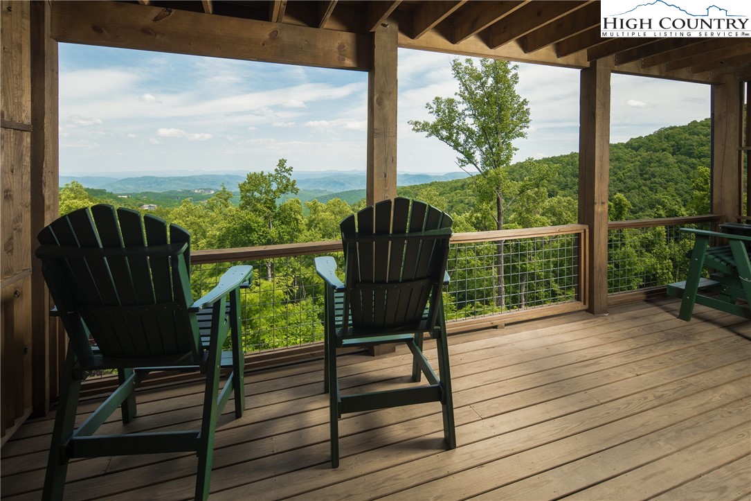 103 Dugger Rdg Trail Boone, NC 28607 - Photo 28 of 49 a view of a balcony with chairs and wooden floor