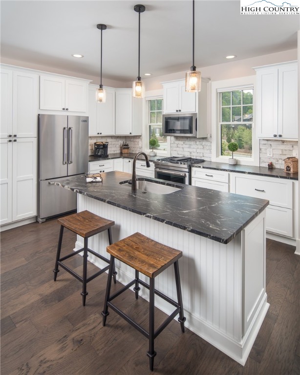 103 Dugger Rdg Trail Boone, NC 28607 - Photo 4 of 49 a kitchen with stainless steel appliances granite countertop a kitchen island a stove a refrigerator a sink a stove and chairs with wooden floor