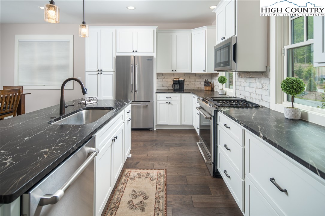 103 Dugger Rdg Trail Boone, NC 28607 - Photo 6 of 49 a kitchen with stainless steel appliances granite countertop a sink stove and refrigerator