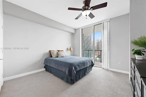 a spacious bedroom with a bed and a window