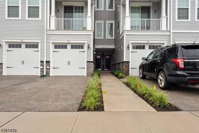 a view of a car parked in front of a house
