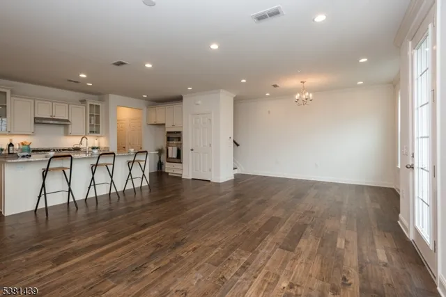 an open kitchen with a sink and breakfast area