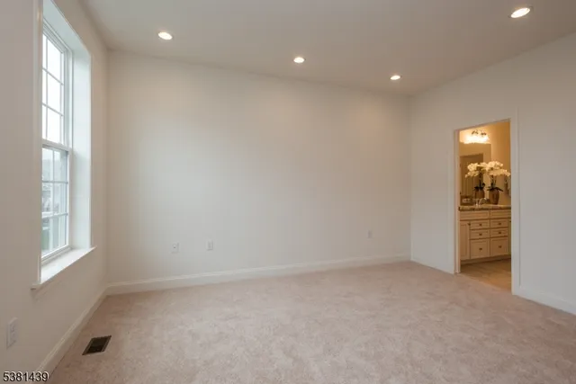 an empty room with windows and closet