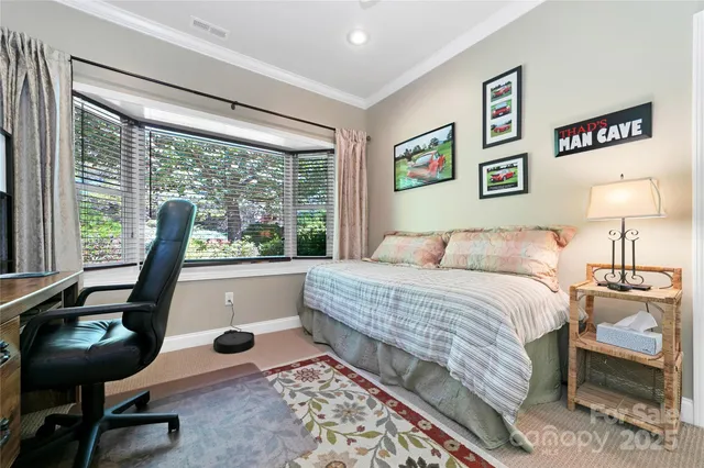 a bedroom with a bed and a large window