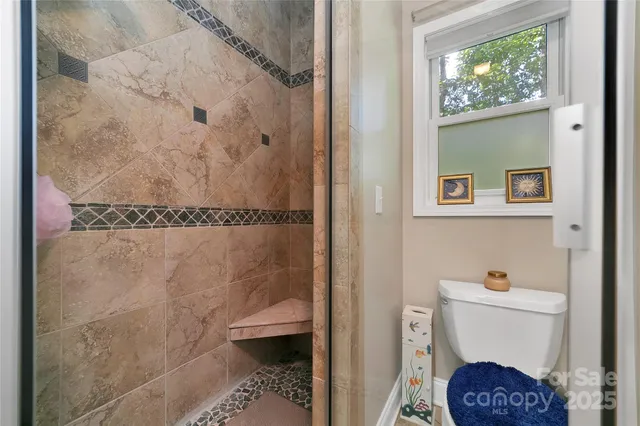 a bathroom with a toilet and a shower