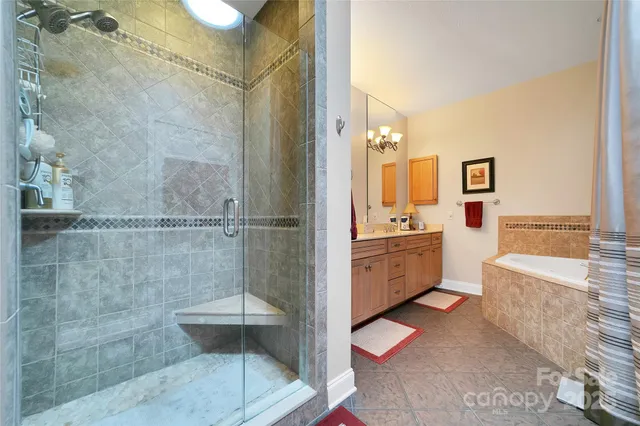 a bathroom with a double vanity sink a toilet a mirror and shower
