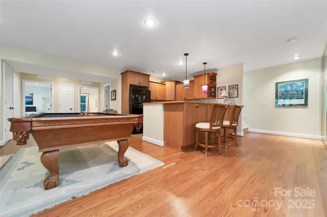 a room with lots of furniture and wooden floor