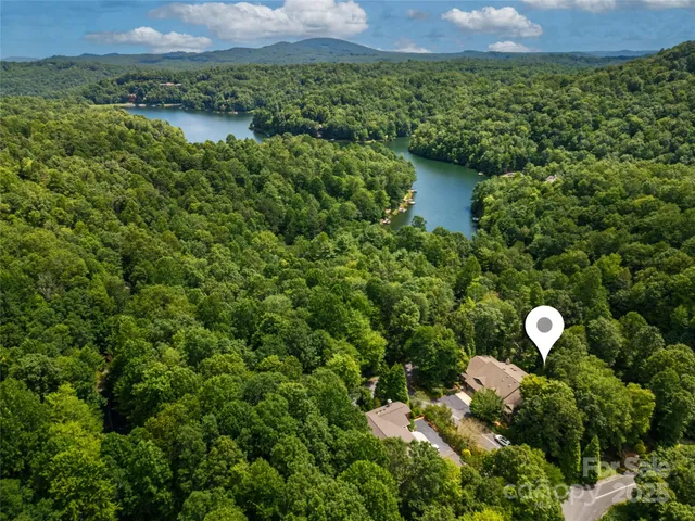 a aerial view of a house with a yard and lake view