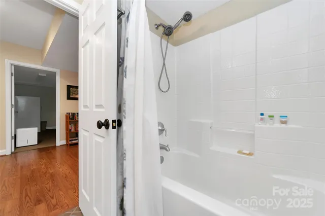 a bathroom with a bathtub with a shower