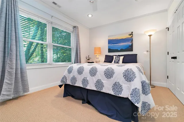 a bedroom with a large bed and a window