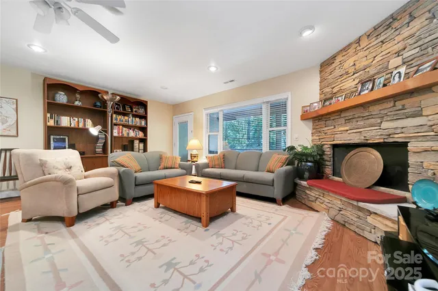 a living room with furniture a rug and a large window