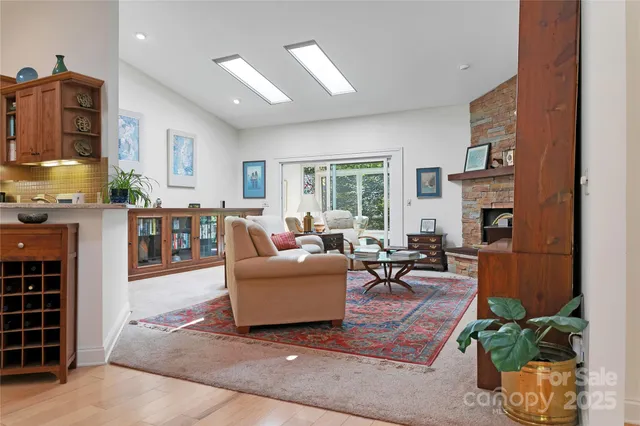 a living room with fireplace furniture and a potted plant