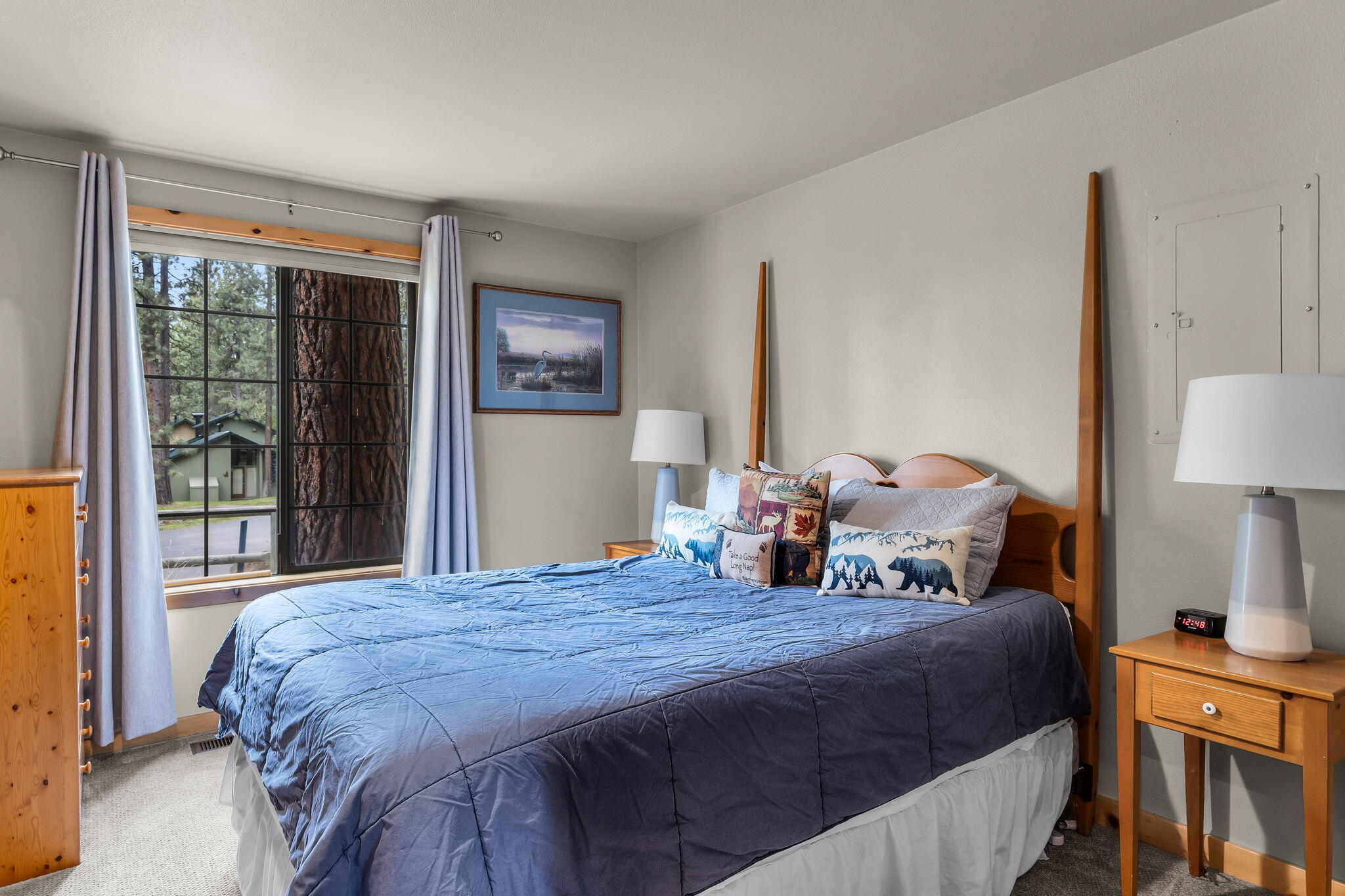 57505 Circle 4 Cabin Road, Unit 29 Sunriver, OR 97707 - Photo 28 of 35 a bedroom with a bed a lamp and a large window