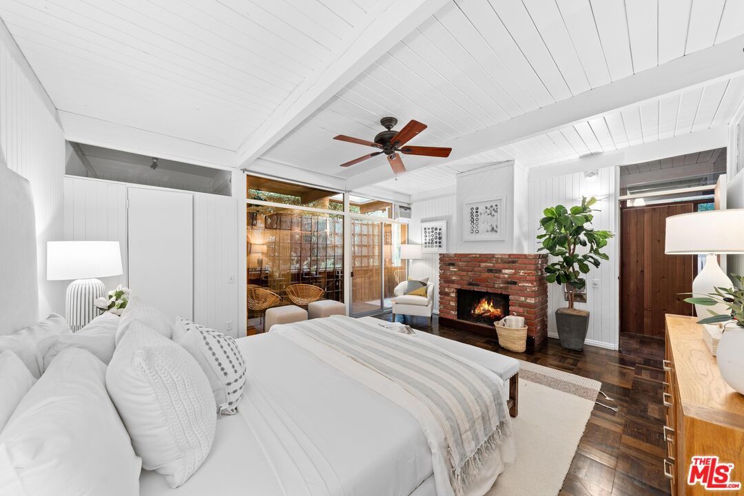 11612 Chenault Street, Unit 4 Los Angeles, CA 90049 - Photo 15 of 28 a bedroom with a bed window and a fireplace