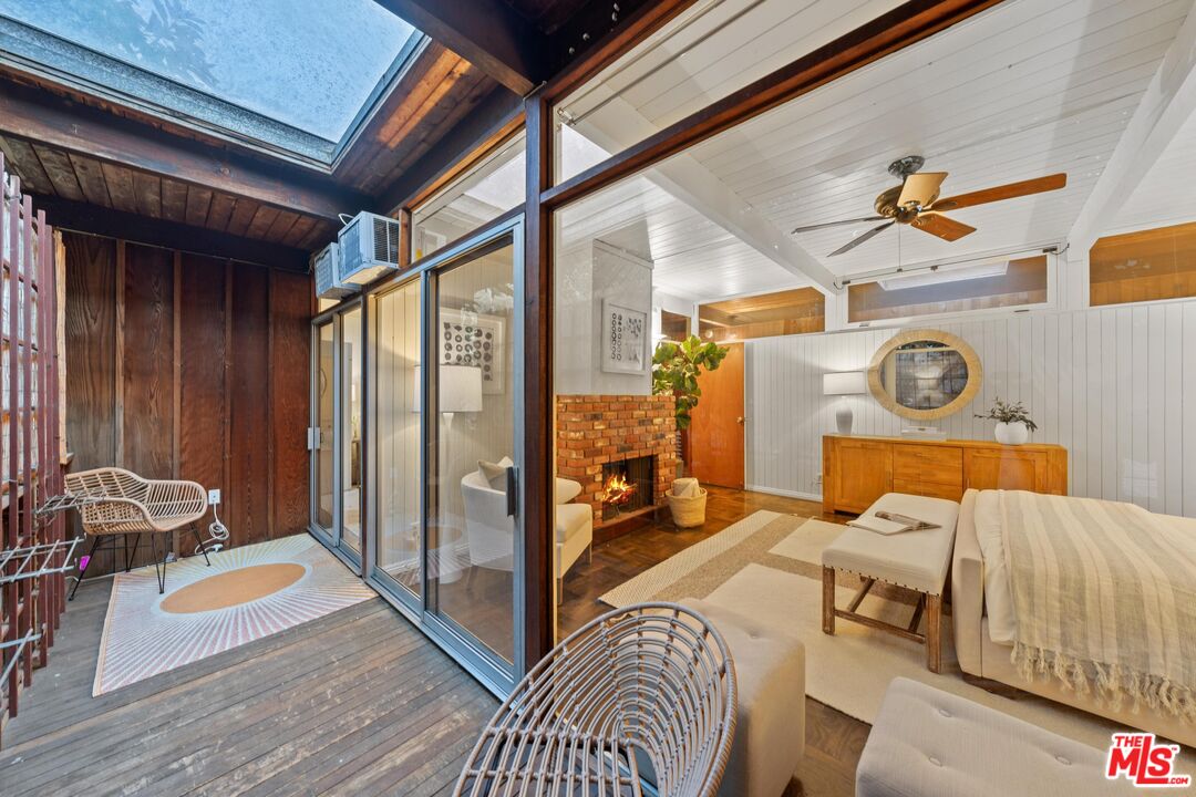 11612 Chenault Street, Unit 4 Los Angeles, CA 90049 - Photo 16 of 28 a bedroom with a bed and wooden floor