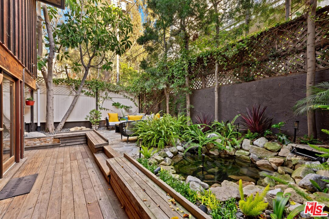 11612 Chenault Street, Unit 4 Los Angeles, CA 90049 - Photo 23 of 28 a view of a backyard with sitting area