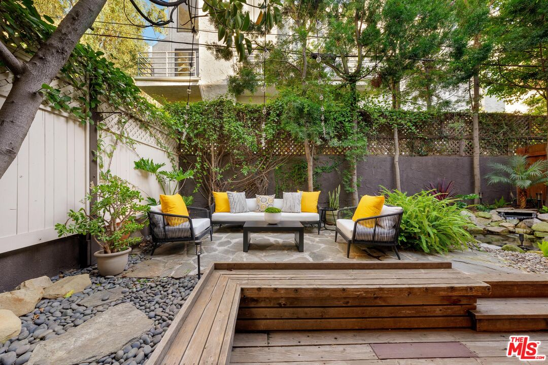11612 Chenault Street, Unit 4 Los Angeles, CA 90049 - Photo 26 of 28 a view of a backyard with sitting area