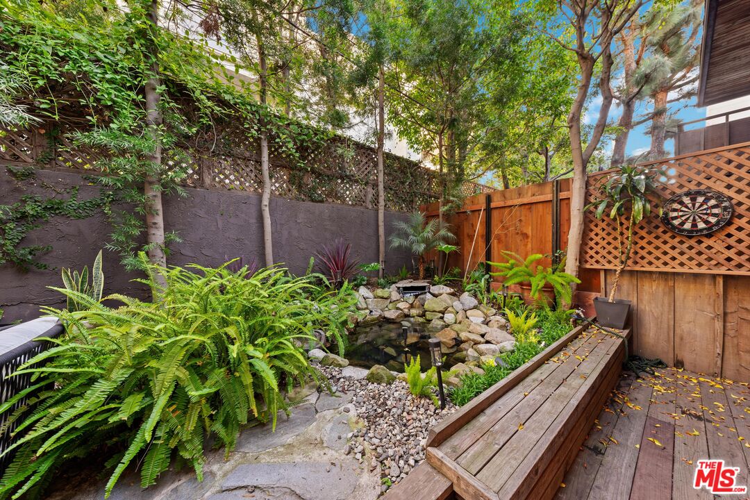 11612 Chenault Street, Unit 4 Los Angeles, CA 90049 - Photo 28 of 28 a view of a garden with flowers