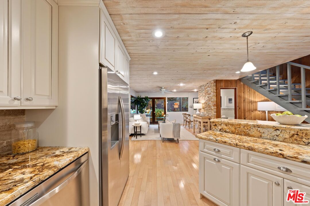 11612 Chenault Street, Unit 4 Los Angeles, CA 90049 - Photo 4 of 28 a view of living room with granite countertop furniture and a fireplace