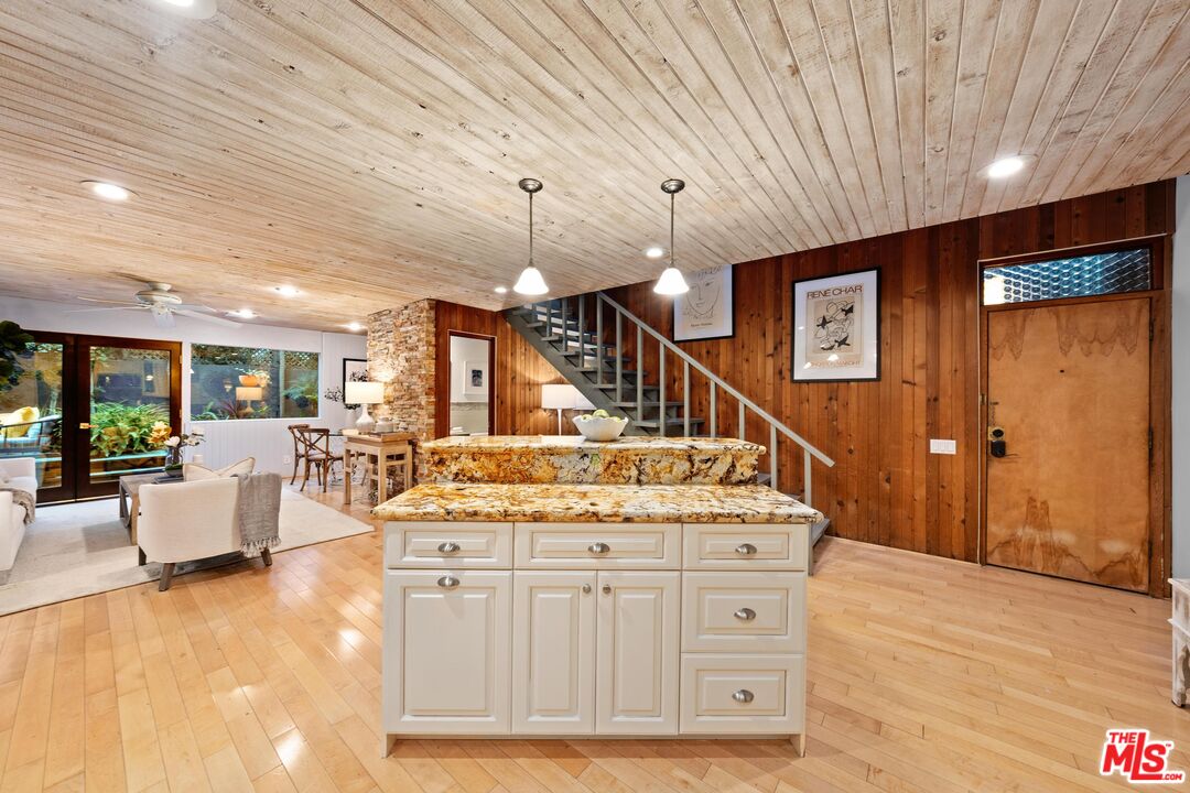11612 Chenault Street, Unit 4 Los Angeles, CA 90049 - Photo 5 of 28 a spacious bathroom with a granite countertop sink a large mirror and shower