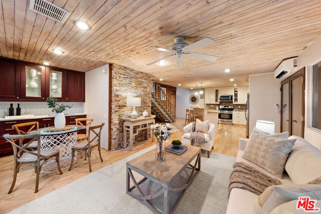 11612 Chenault Street, Unit 4 Los Angeles, CA 90049 - Photo 9 of 28 a living room with furniture kitchen view and a large window