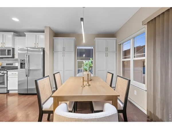 a view of a dining room with furniture and wooden floor