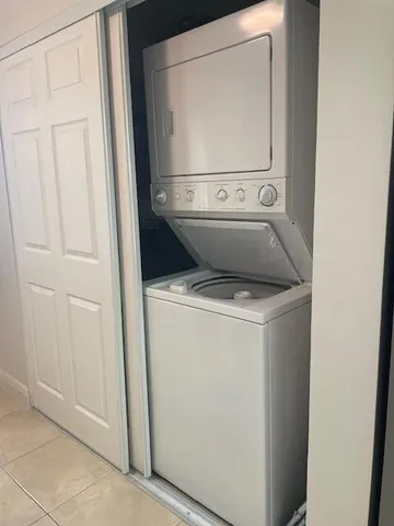a view of a livingroom with a floor to ceiling window and wooden floor