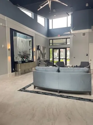a view of a porch with furniture and a yard
