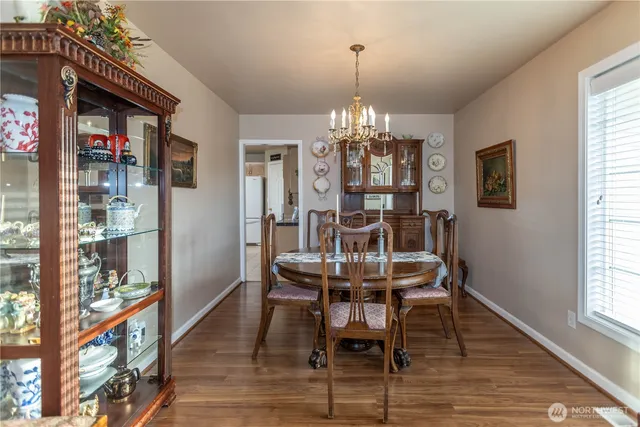 a view of a dining room with furniture and chandelier
