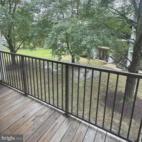 a balcony with wooden floor and fence
