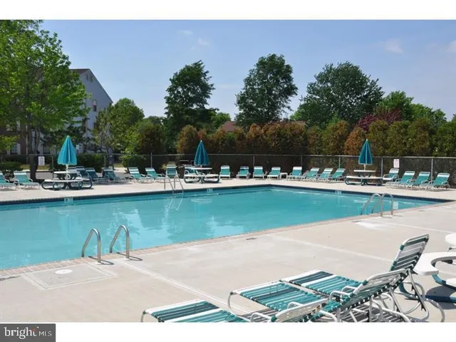 a view of a lake with a table and chairs