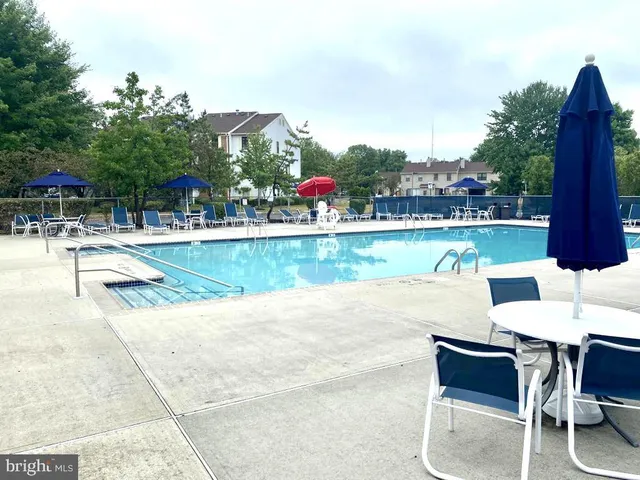 a view of swimming pool with outdoor seating and city view