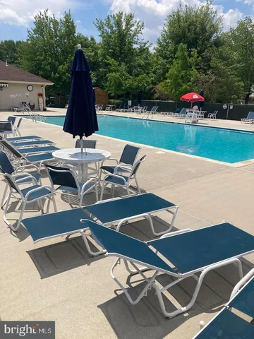 a view of swimming pool with seating space