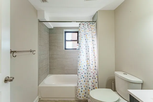 a bathroom with a toilet and shower