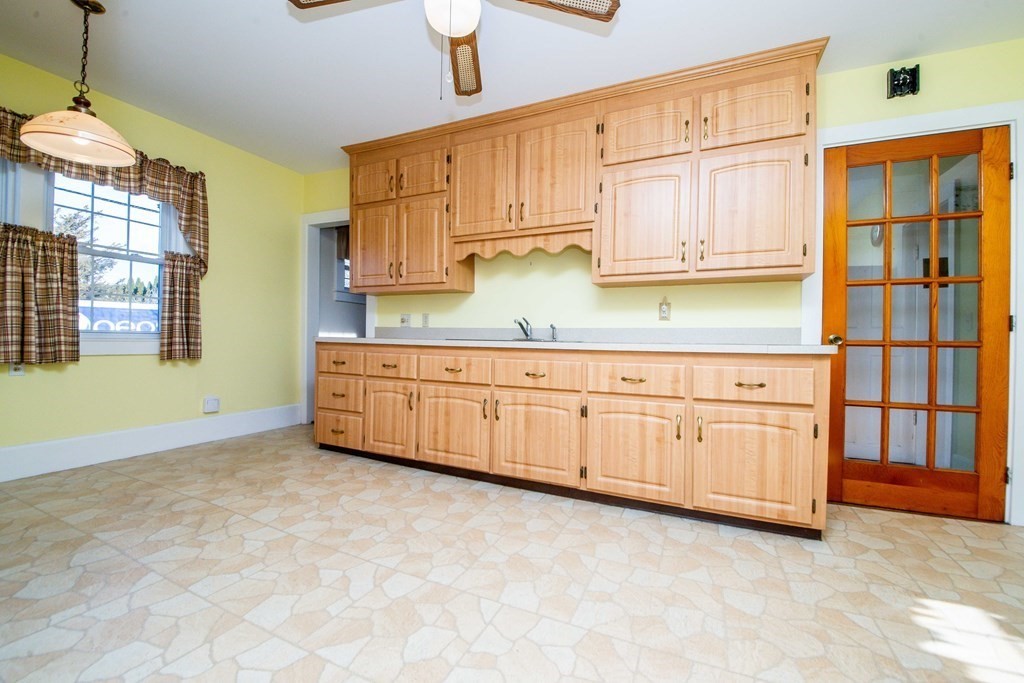 236 Russells Mills Road Dartmouth, MA 02748 - Photo 12 of 30 a kitchen with granite countertop a stove a sink and dishwasher cabinets with wooden floor
