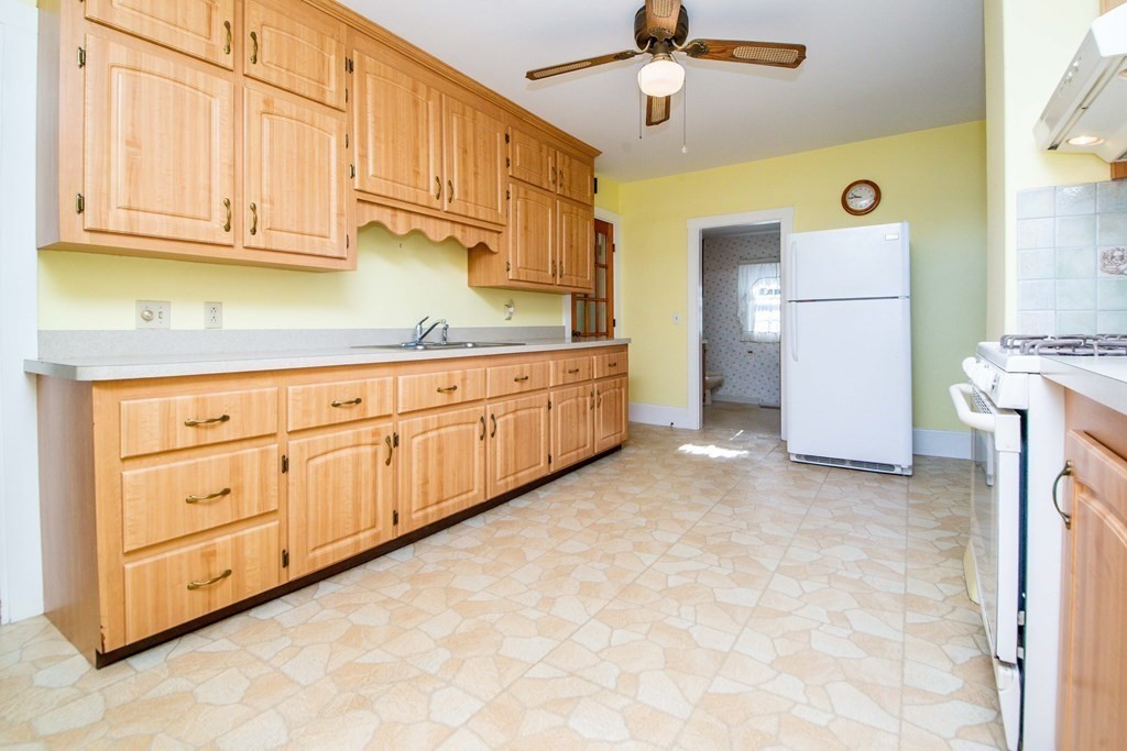 236 Russells Mills Road Dartmouth, MA 02748 - Photo 14 of 30 a kitchen with granite countertop a sink a stove and a refrigerator