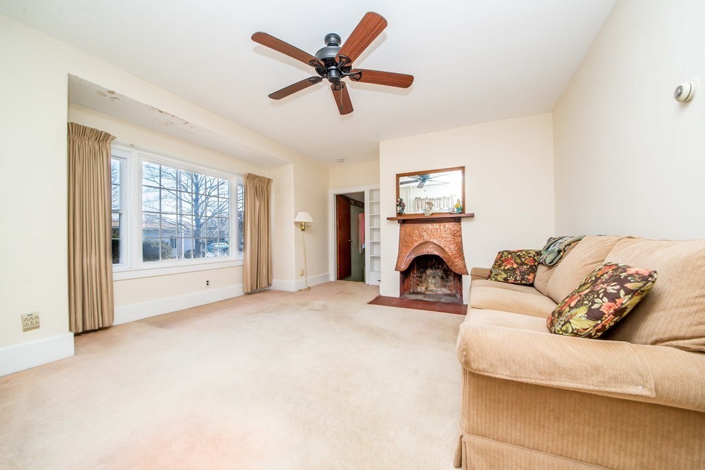 236 Russells Mills Road Dartmouth, MA 02748 - Photo 17 of 30 a living room with furniture a fireplace with a large window