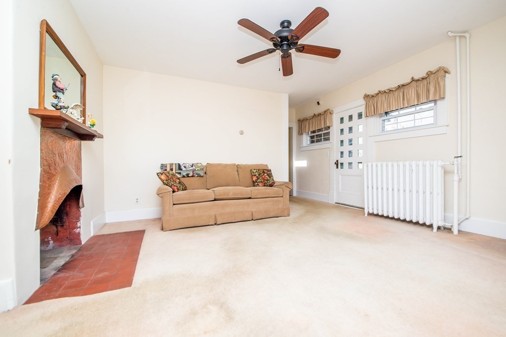 236 Russells Mills Road Dartmouth, MA 02748 - Photo 19 of 30 a living room with furniture and a fireplace
