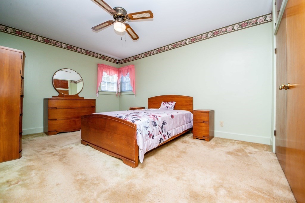 236 Russells Mills Road Dartmouth, MA 02748 - Photo 20 of 30 a bedroom with a bed mirror and a ceiling fan