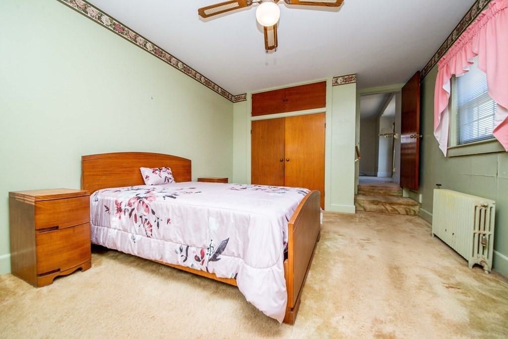 236 Russells Mills Road Dartmouth, MA 02748 - Photo 21 of 30 a bedroom with a bed and a chandelier