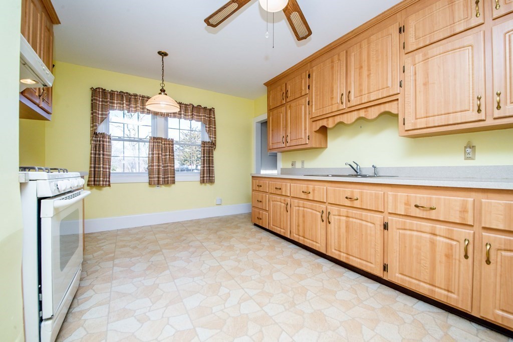 236 Russells Mills Road Dartmouth, MA 02748 - Photo 10 of 30 a kitchen with granite countertop white cabinets white stainless steel appliances with a sink and dishwasher
