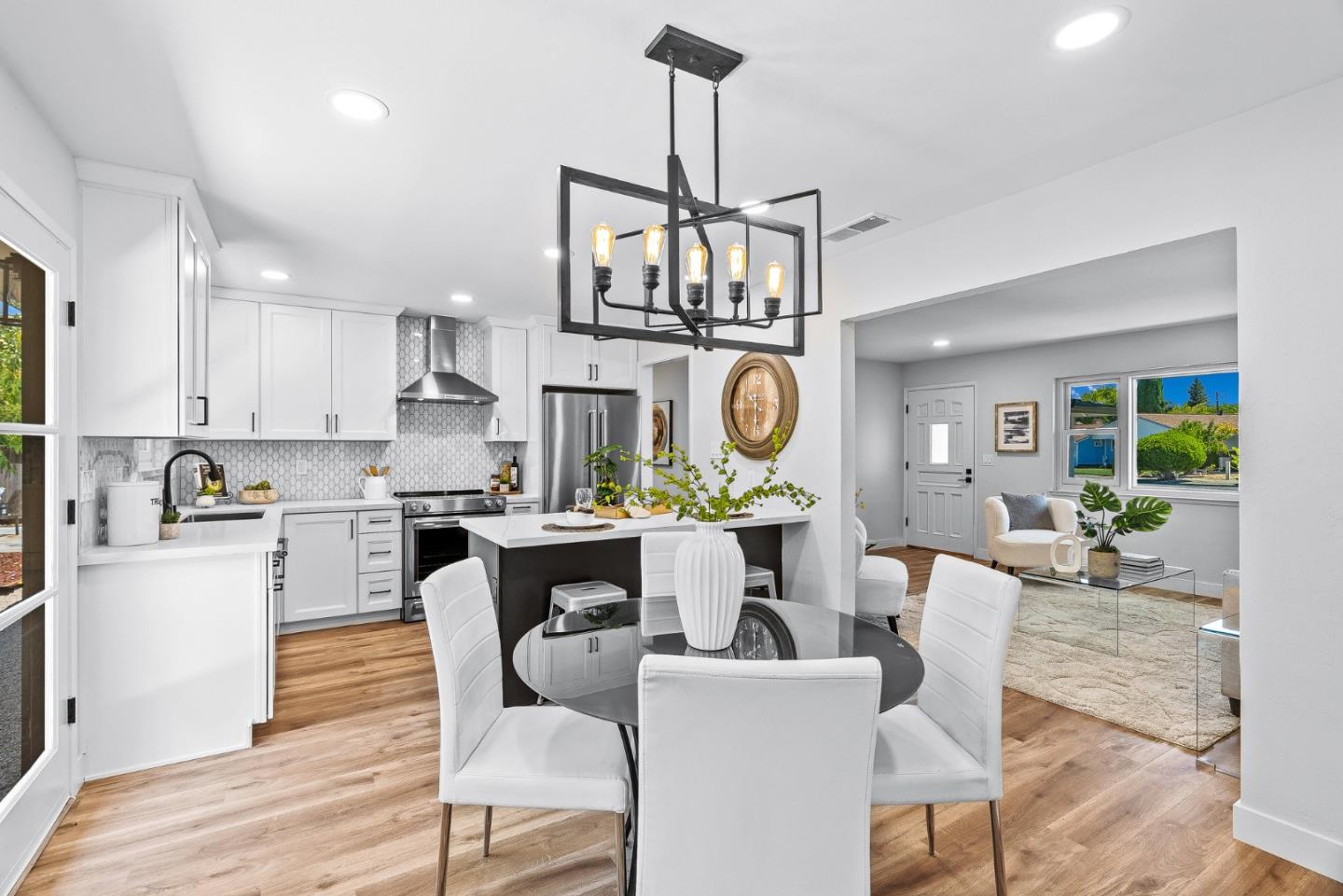 3763 Xavier Court Campbell, CA 95008 - Photo 13 of 41 a living room with stainless steel appliances kitchen island granite countertop furniture and a wooden floor