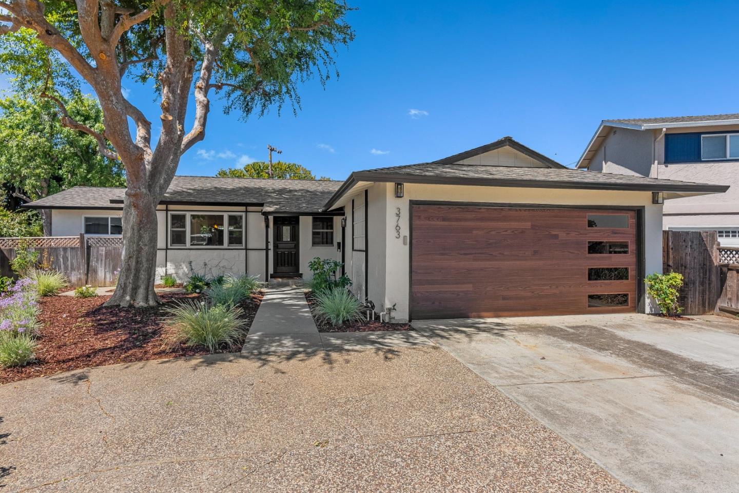 3763 Xavier Court Campbell, CA 95008 - Photo 4 of 41 a front view of a house with a yard and garage